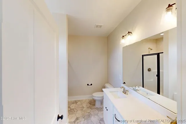 a bathroom with a tub a sink and glass door
