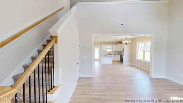 a view of a hallway with wooden floor and furniture