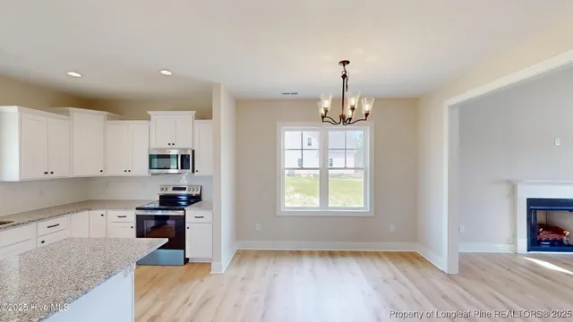 a kitchen that has a lot of cabinets in it with granite countertop wooden cabinets