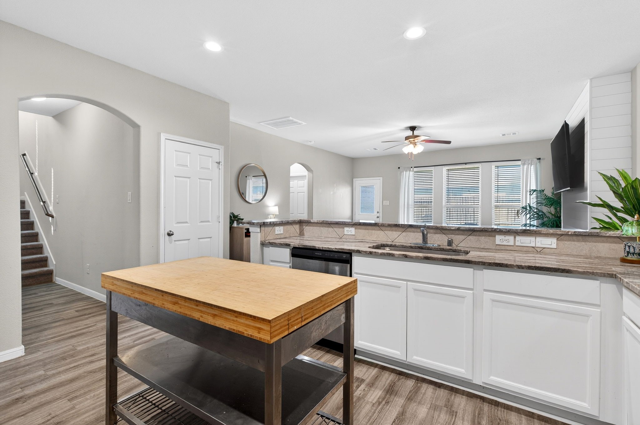 2121 Cedar Way Drive Conroe, TX 77301 - Photo 7 of 27 a kitchen with a stove a sink a dining table and chairs