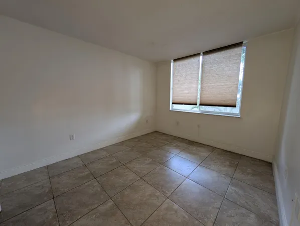 an empty room with a empty space and windows