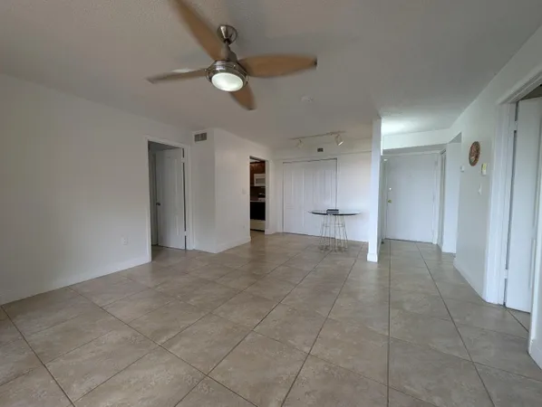 a view of an empty room and a ceiling fan