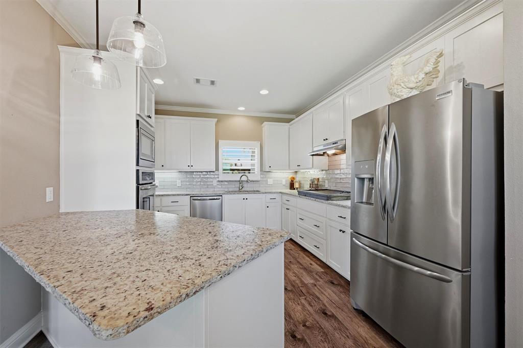 662 Preakness Place Road Van Alstyne, TX 75495 - Photo 9 of 39 a kitchen with a refrigerator a sink and cabinets