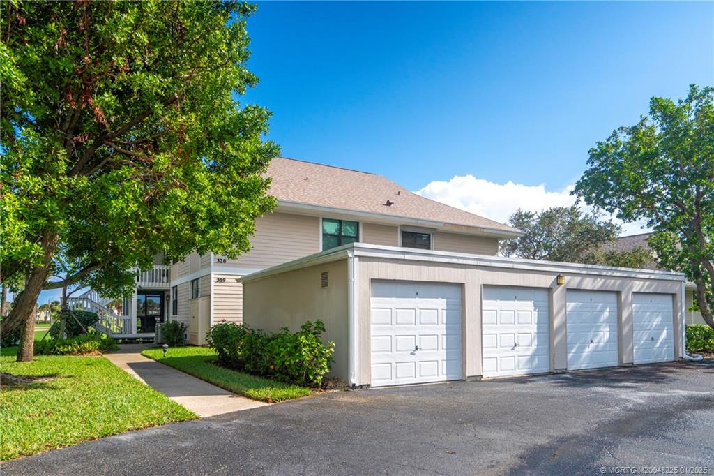 319 Golfview Circle, Unit 319 Stuart, FL 34996 - Photo 13 of 56 front view of a house with a yard