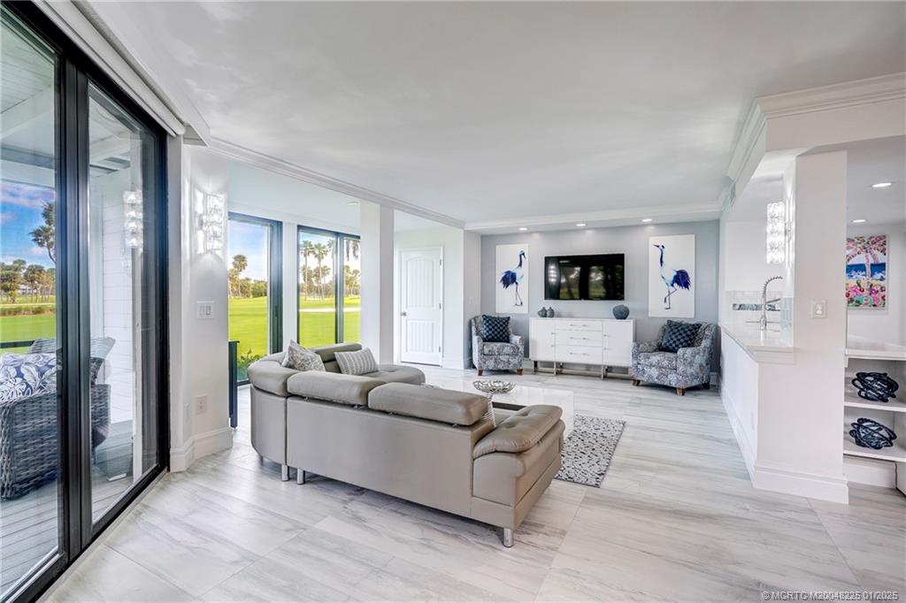 319 Golfview Circle, Unit 319 Stuart, FL 34996 - Photo 21 of 56 a living room with furniture and a flat screen tv