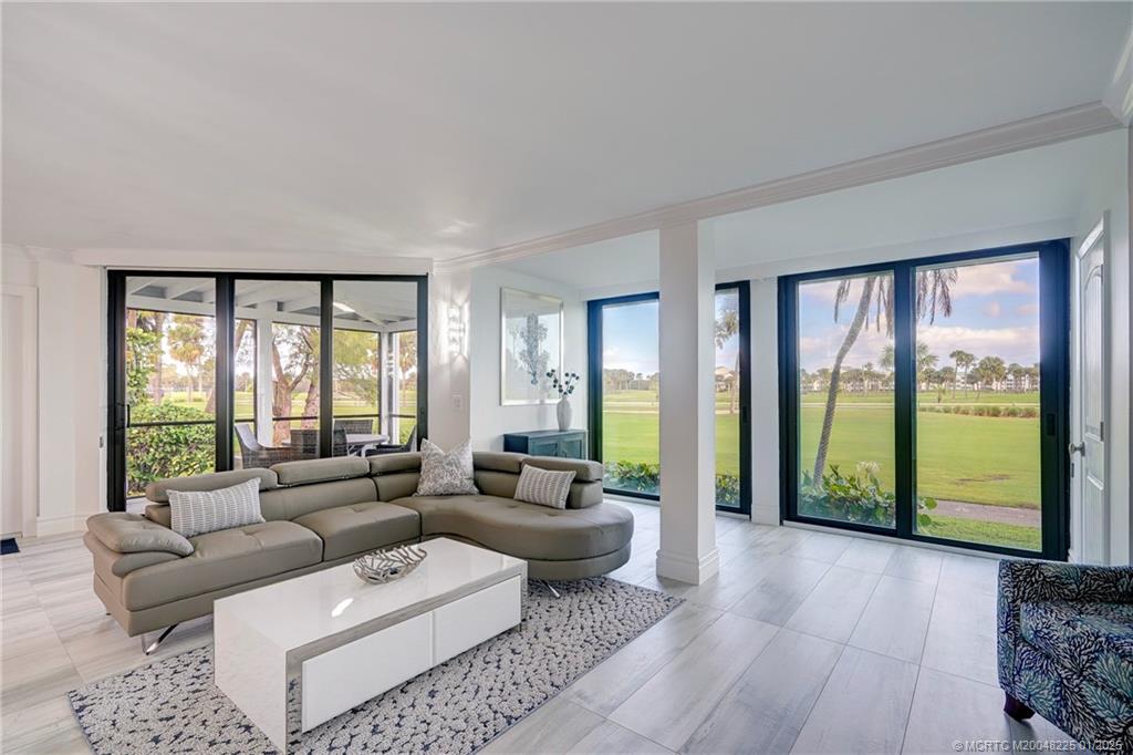 319 Golfview Circle, Unit 319 Stuart, FL 34996 - Photo 27 of 56 a living room with furniture and a large window