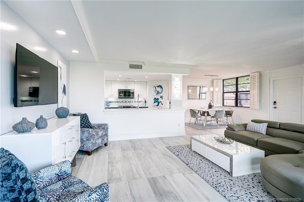 319 Golfview Circle, Unit 319 Stuart, FL 34996 - Photo 30 of 56 a living room with furniture and a flat screen tv