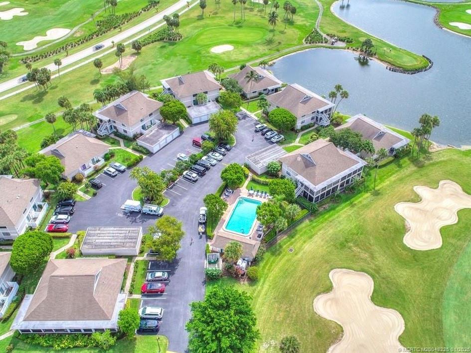 319 Golfview Circle, Unit 319 Stuart, FL 34996 - Photo 3 of 56 an aerial view of a house with a yard and lake view in back