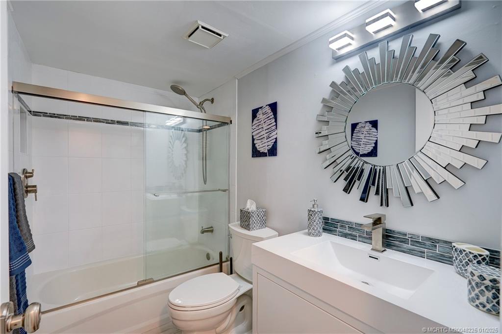 319 Golfview Circle, Unit 319 Stuart, FL 34996 - Photo 36 of 56 a bathroom with a sink a toilet and shower