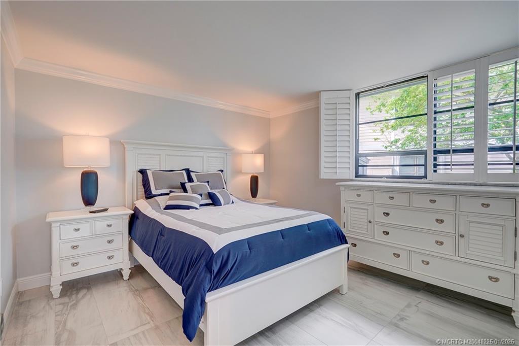 319 Golfview Circle, Unit 319 Stuart, FL 34996 - Photo 38 of 56 a bedroom with a bed and a dresser