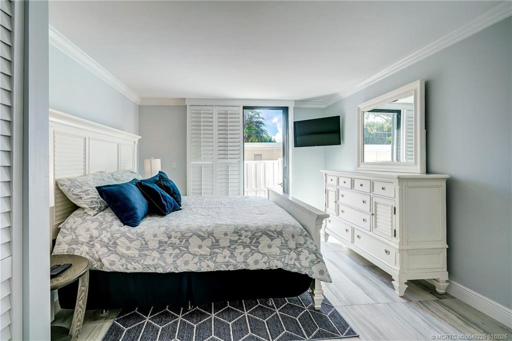 319 Golfview Circle, Unit 319 Stuart, FL 34996 - Photo 42 of 56 a bedroom with a large bed and a window