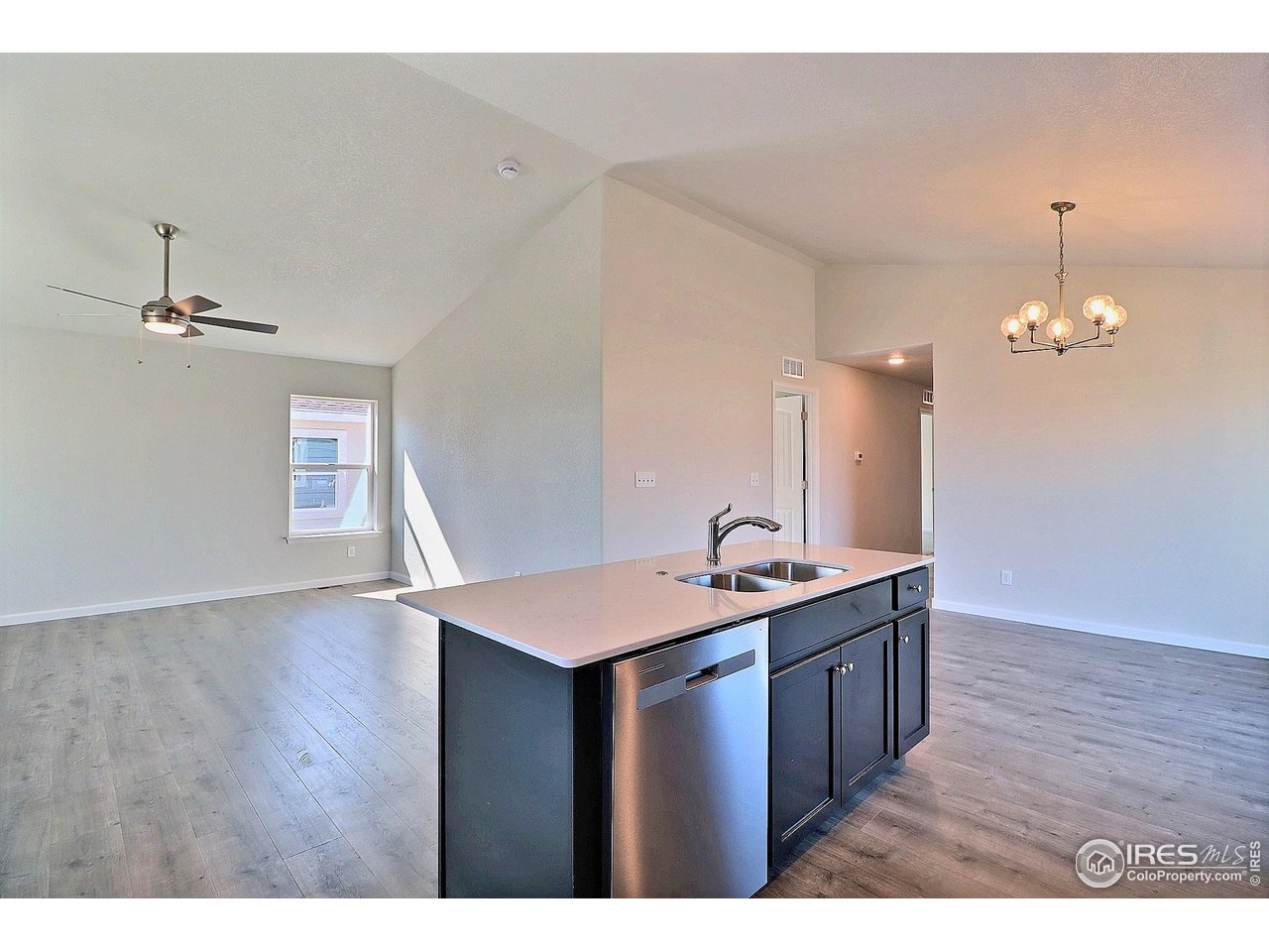 4301 Rockcress Road Evans, CO 80620 - Photo 12 of 26 a kitchen with a sink and chandelier