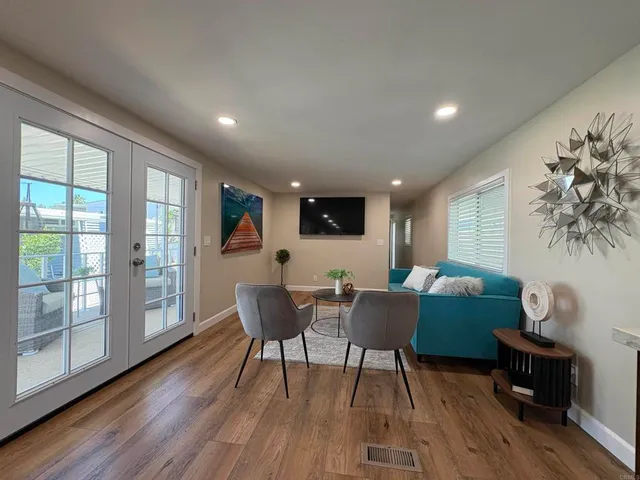 a living room with furniture and a wooden floor