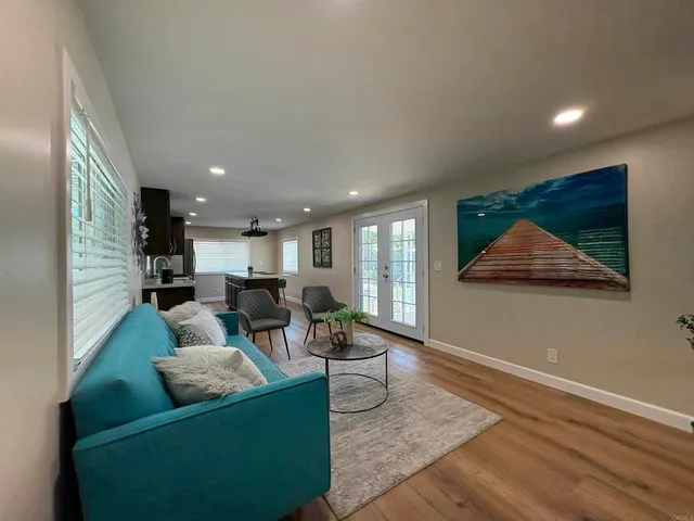 a living room with furniture and kitchen view