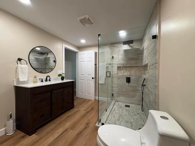 a bathroom with a sink a toilet and shower