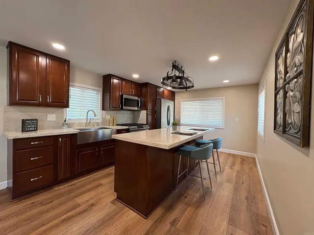 a kitchen with a sink cabinets and wooden floor