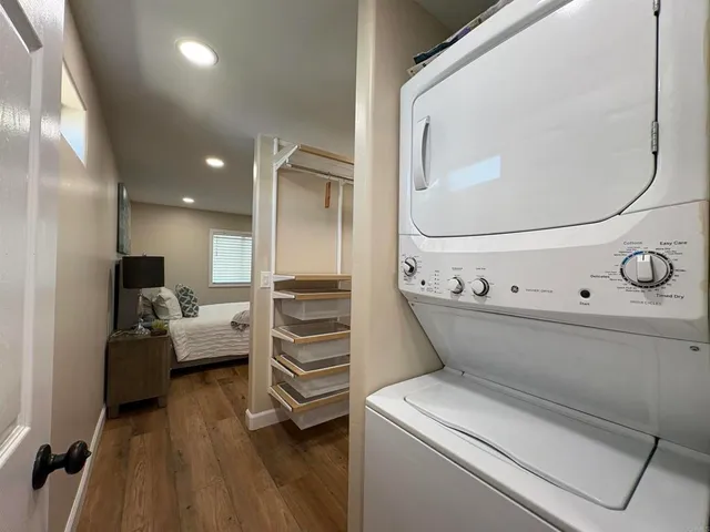 a view of washer and dryer with wooden floor
