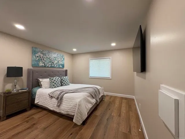 a bedroom with a bed and a night stand