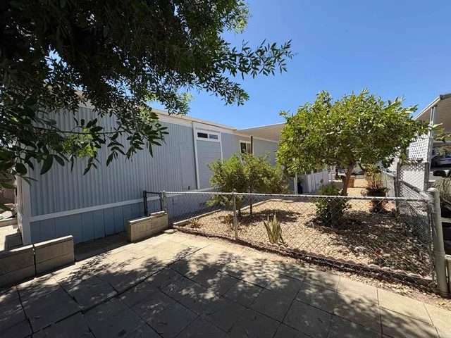 a view of backyard with swimming pool and outdoor seating