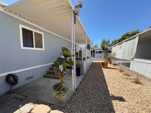 a view of a backyard with sitting area
