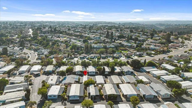 an aerial view of residential houses with city view