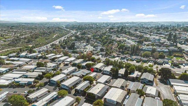 an aerial view of residential houses with city view