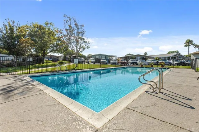a view of a swimming pool with lounge chairs
