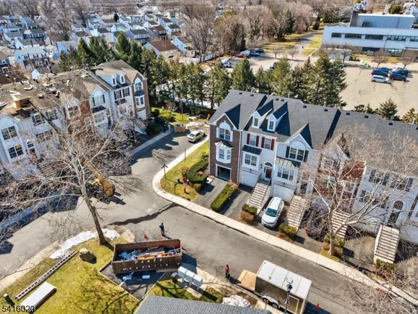 an aerial view of multiple houses with yard