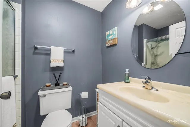 a bathroom with a toilet a sink and mirror