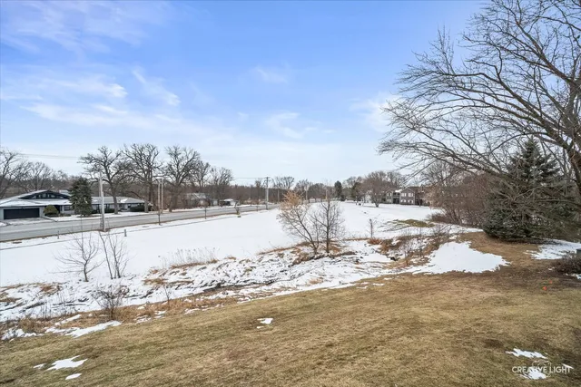 a view of a yard with snow on the road