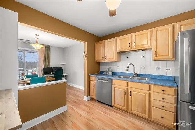 a kitchen with sink a stove and cabinets