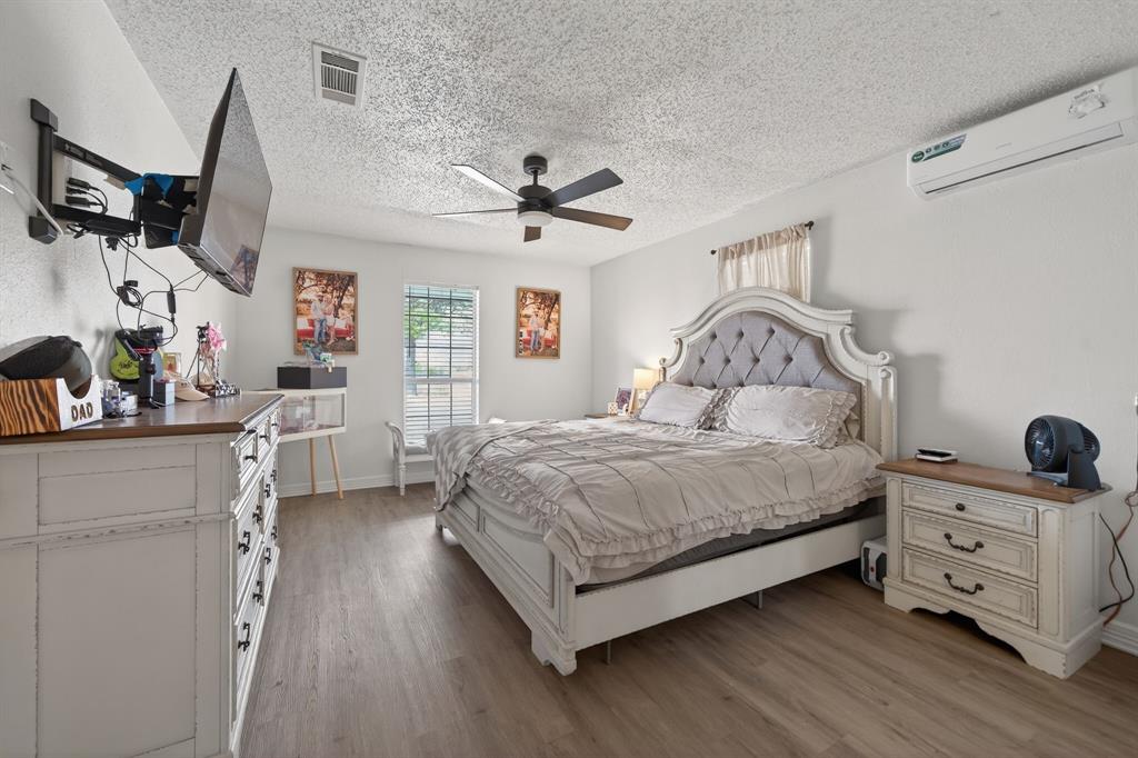 11474 Farm To Market 3094 Scurry, TX 75158 - Photo 14 of 40 a bedroom with a bed a dresser and potted plants