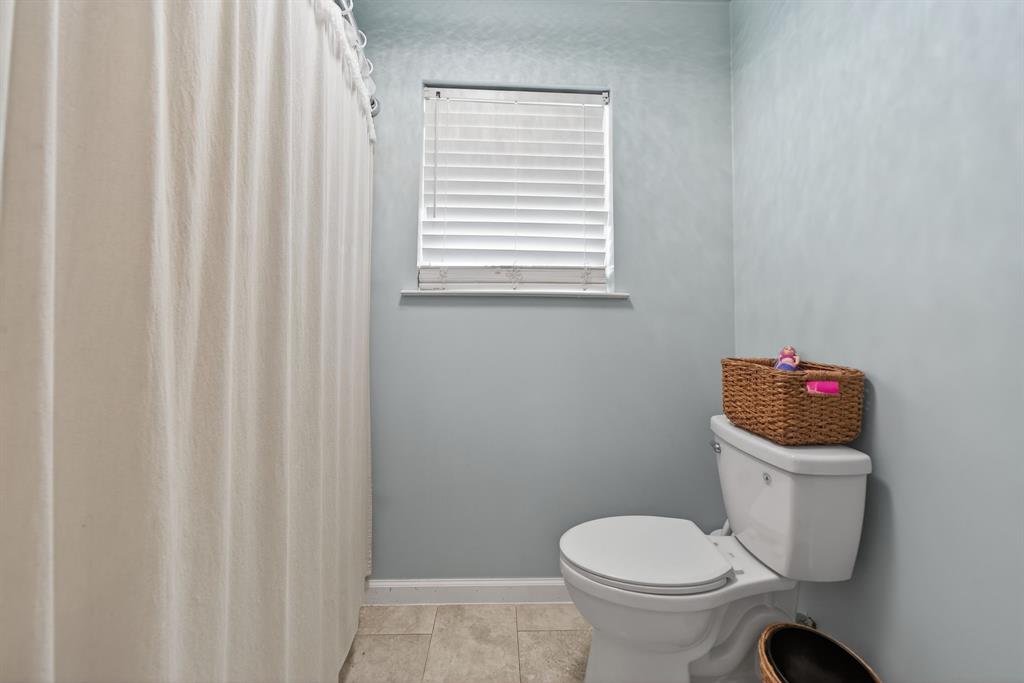 11474 Farm To Market 3094 Scurry, TX 75158 - Photo 24 of 40 a white toilet sitting next to a small bathroom sink