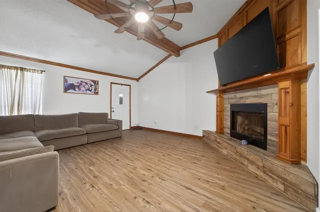 a living room with furniture and a fireplace