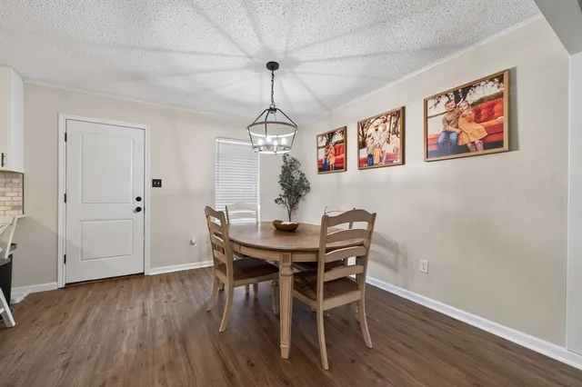 a view of a dining room with furniture wooden floor and chandelier