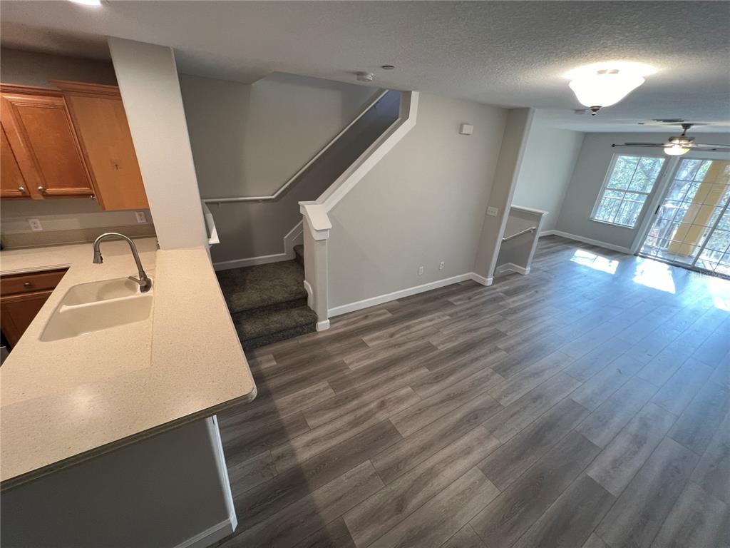 7350 Black Walnut Way Lakewood Ranch, FL 34202 - Photo 12 of 52 a view of a kitchen with a sink and dishwasher with wooden floor