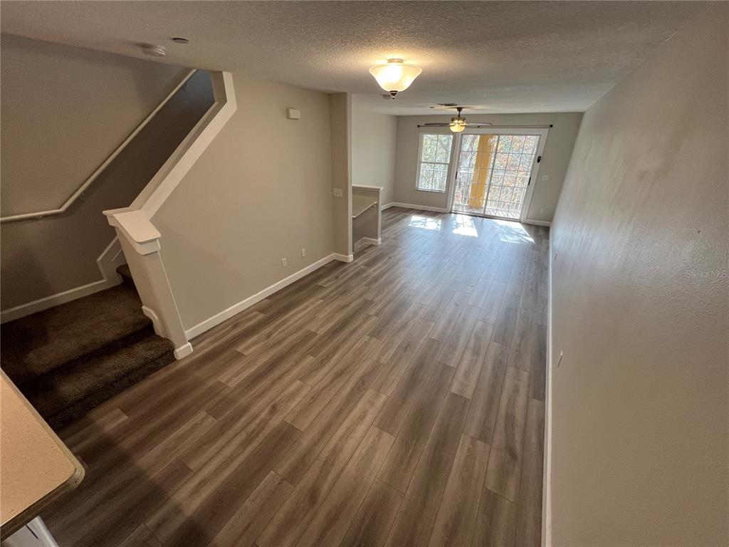 7350 Black Walnut Way Lakewood Ranch, FL 34202 - Photo 13 of 52 a view of an empty room with wooden floor and a window