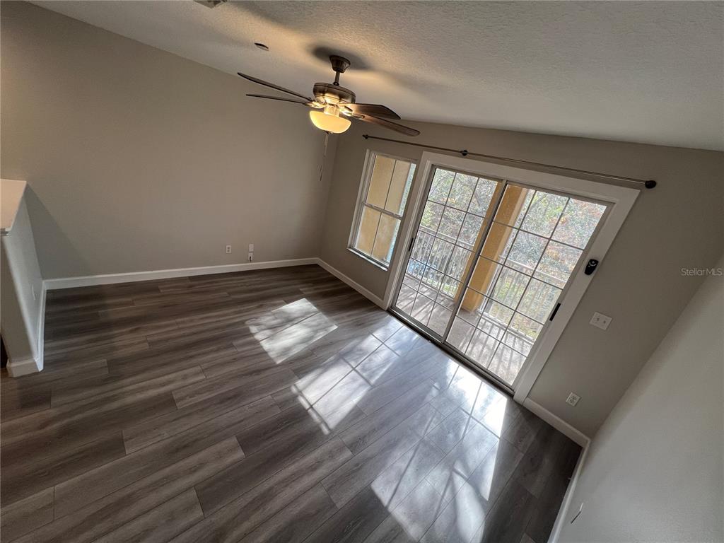 7350 Black Walnut Way Lakewood Ranch, FL 34202 - Photo 15 of 52 a view of an empty room with wooden floor and a window