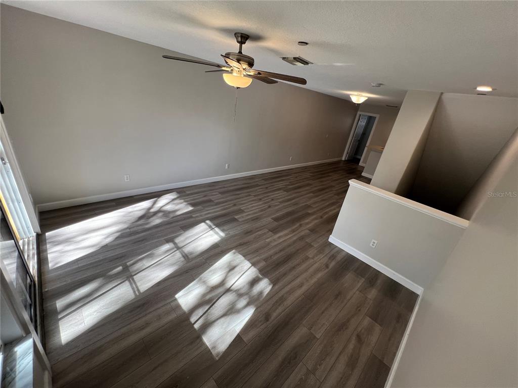 7350 Black Walnut Way Lakewood Ranch, FL 34202 - Photo 19 of 52 a view of an empty room with wooden floor and a window