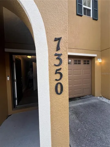a hallway view with wooden floor and staircase