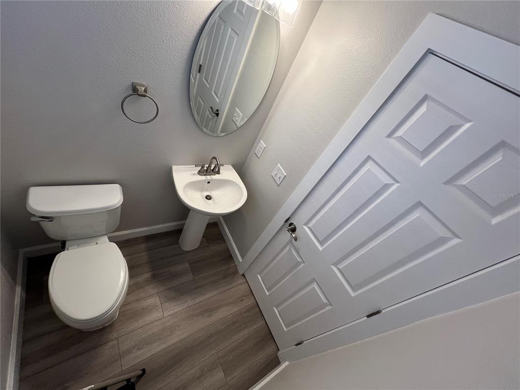 7350 Black Walnut Way Lakewood Ranch, FL 34202 - Photo 21 of 52 a view of a bathroom with a toilet and a sink