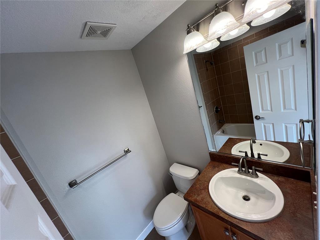 7350 Black Walnut Way Lakewood Ranch, FL 34202 - Photo 33 of 52 a bathroom with a sink a toilet and a mirror