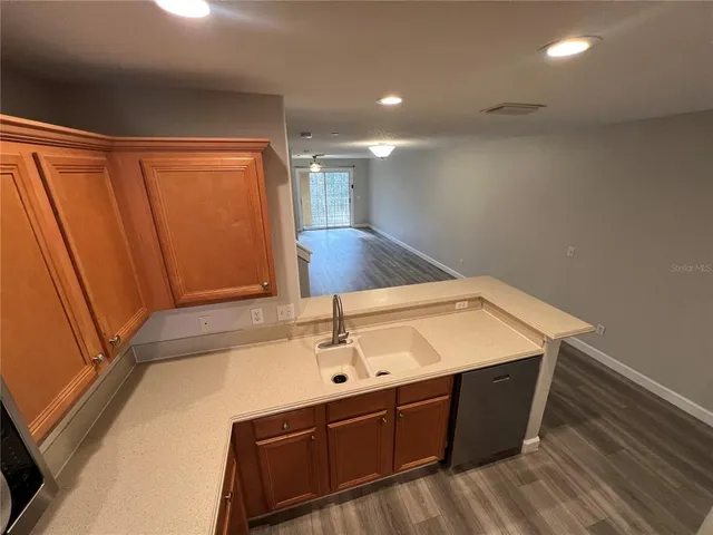 a kitchen with stainless steel appliances a refrigerator sink stove microwave and cabinets