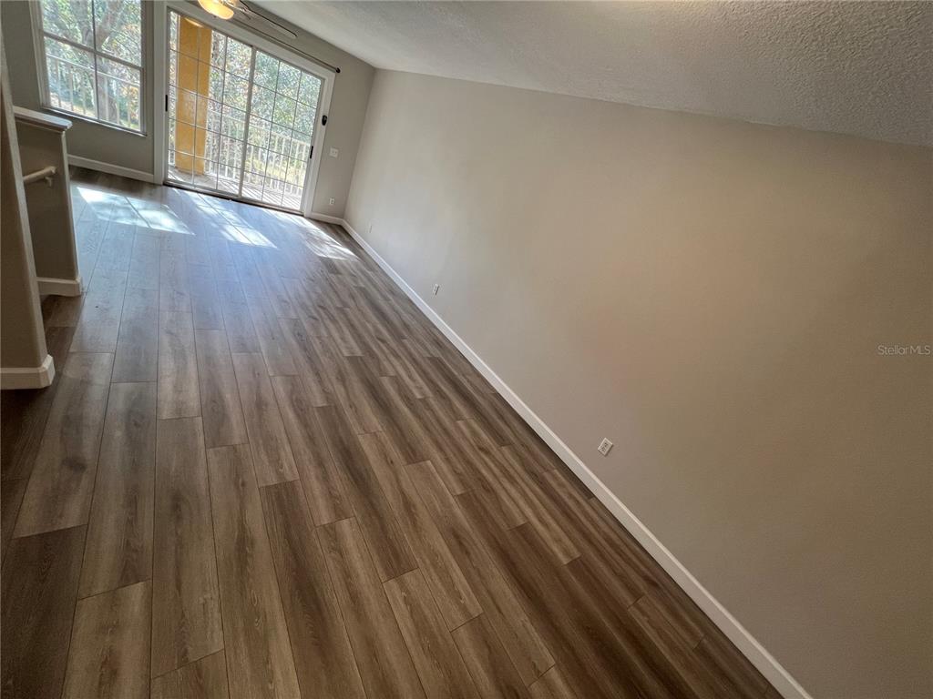 7350 Black Walnut Way Lakewood Ranch, FL 34202 - Photo 44 of 52 a view of an empty room with wooden floor and a window