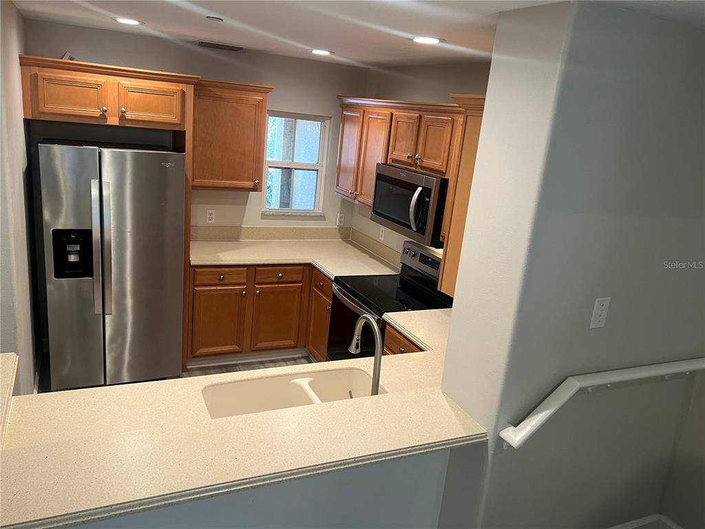 7350 Black Walnut Way Lakewood Ranch, FL 34202 - Photo 10 of 52 a kitchen with a refrigerator and a sink