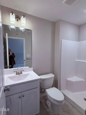 a bathroom with a sink a toilet and mirror