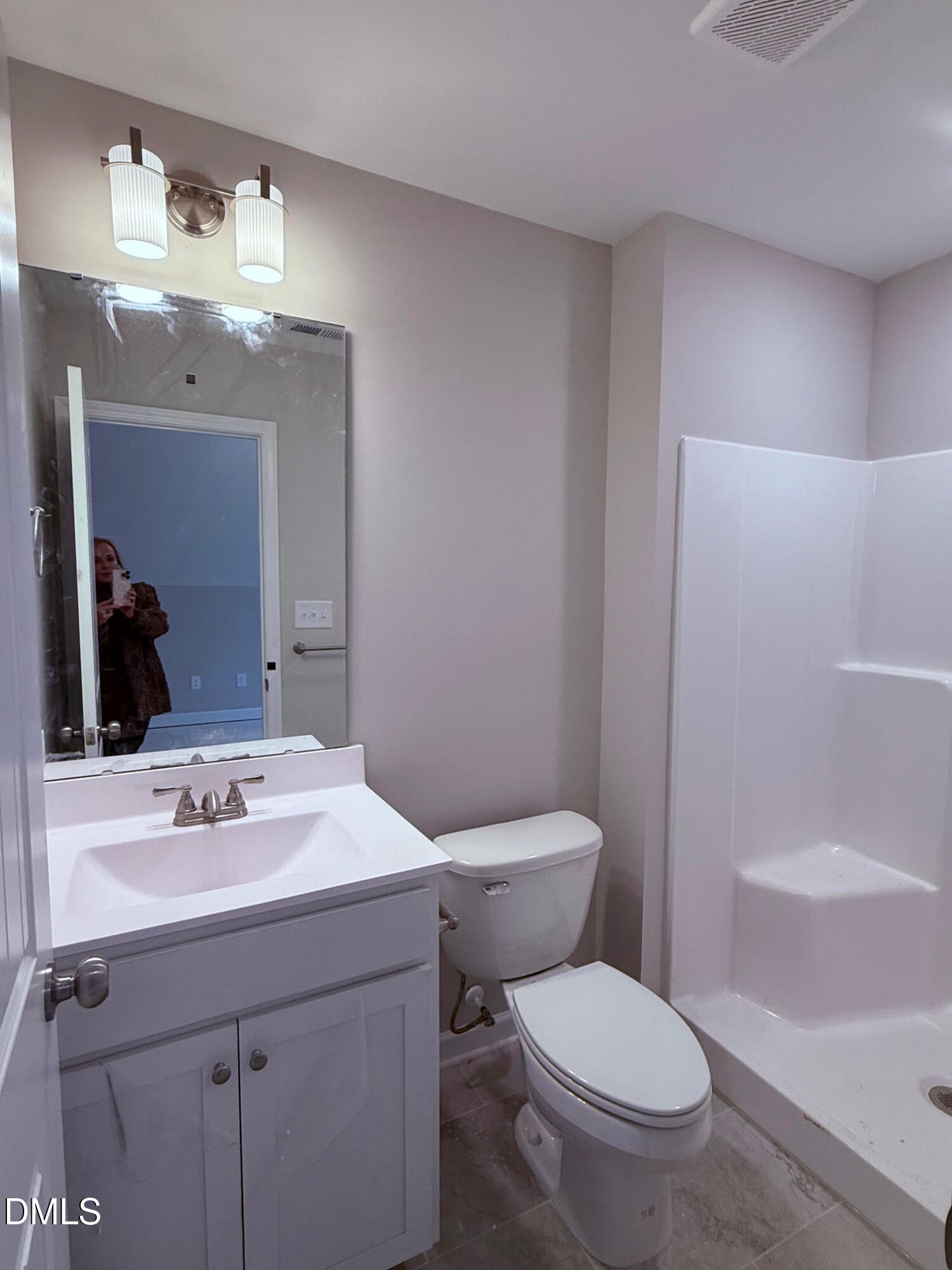 191 Seahawk Way Zebulon, NC 27597 - Photo 14 of 21 a bathroom with a sink a toilet and mirror