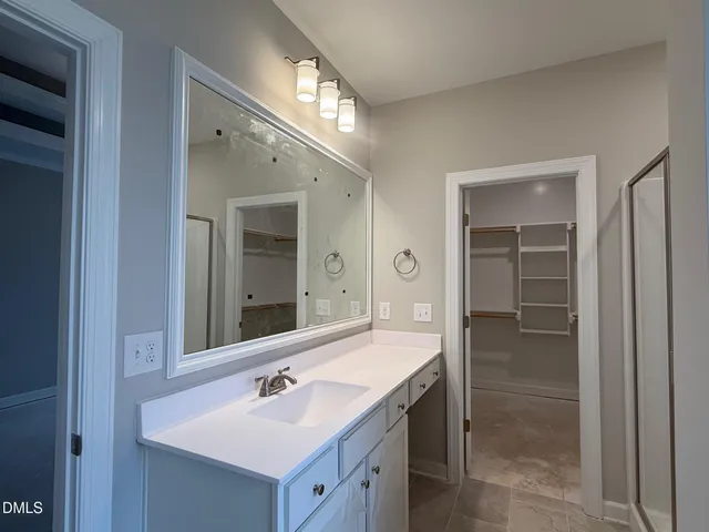 a bathroom with a sink double vanity and a mirror