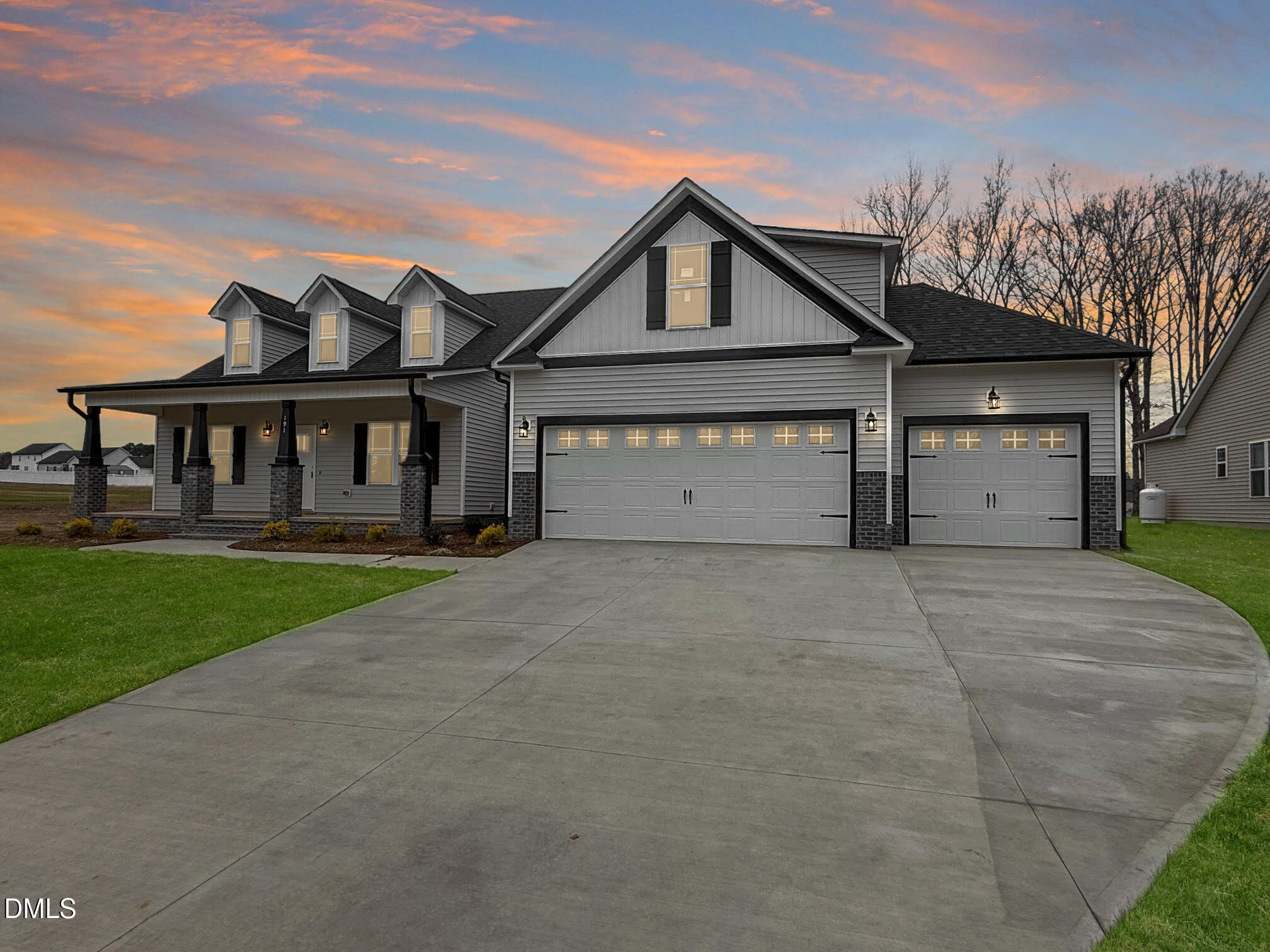 191 Seahawk Way Zebulon, NC 27597 - Photo 2 of 21 front view of a house with a yard and a garage
