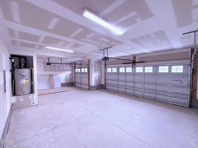 a view of an empty room with a cabinet and mirrors